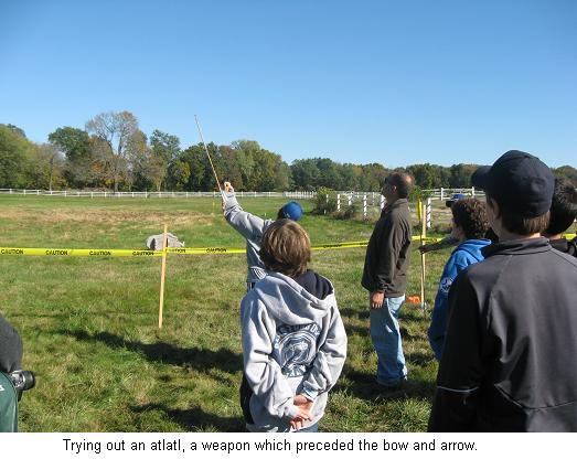 Trying out an atlatl, a weapon which preceded the bow and arrow.