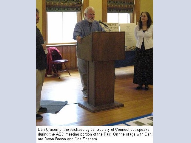 Dan Cruson of the Archaeological Society of Connecticut speaks during the
                                          A.S.C. meeting portion of the Fair. On stage with Dan are Dawn Brown
                                          and Cos Sgarlata.