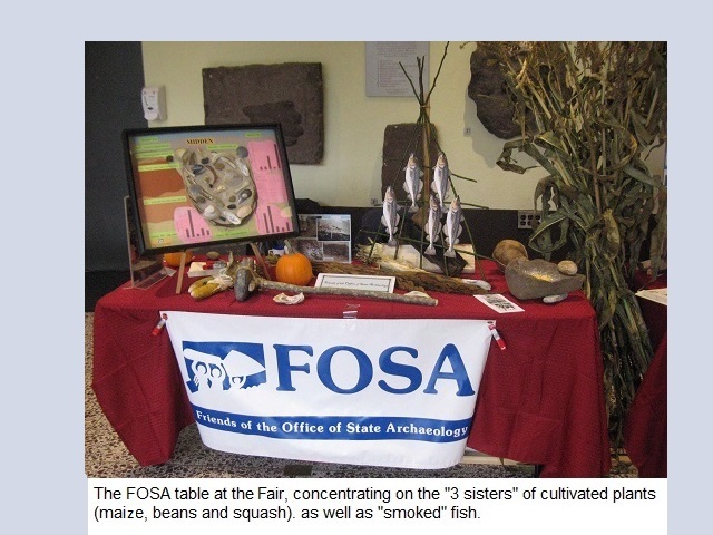 The FOSA table at the Fair, concentrating on the '3 sisters' of
                                          cultivated plants(maize, beans ansd squash) as well as 'smoked' fish.