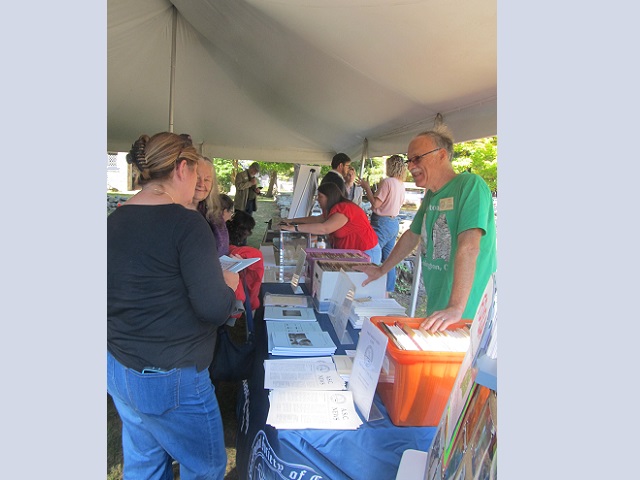 October 5, 2024 Left to right: Sarah Sportman (back to camera), 
                                              Lucianne Lavin (face peeking around Sarah), and Lee West (green shirt) 
                                              at the Archaeological Society of CT (ASC) table.